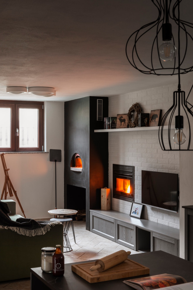 Design ideas for a small country walk-out basement in Milan with white walls, ceramic flooring and a tiled fireplace surround.