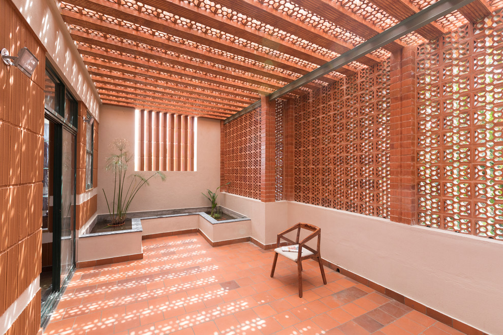 Photo of a large world-inspired patio in Bengaluru with a roof extension.