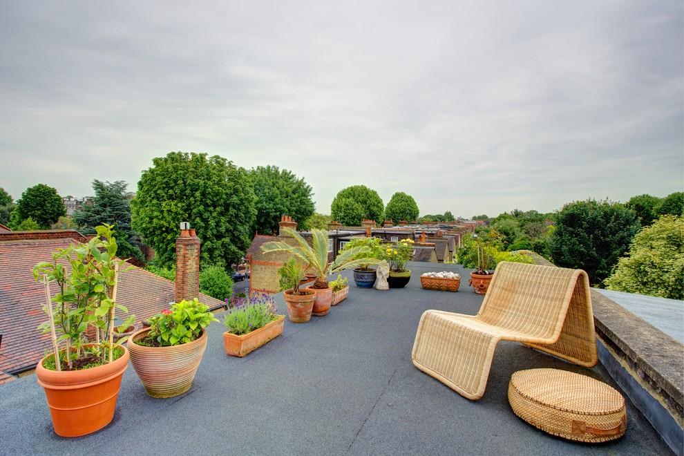 This is an example of a contemporary roof rooftop terrace in London with a potted garden and no cover.