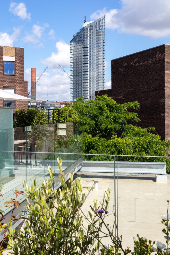 Inspiration for a medium sized contemporary roof terrace in London with a water feature and no cover.