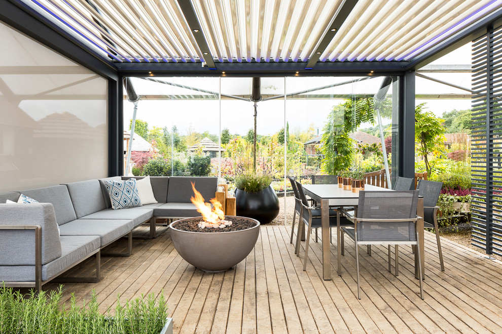This is an example of a medium sized contemporary terrace in Surrey with a fire feature.