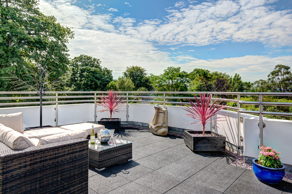 Inspiration for a contemporary rooftop rooftop deck remodel in Devon