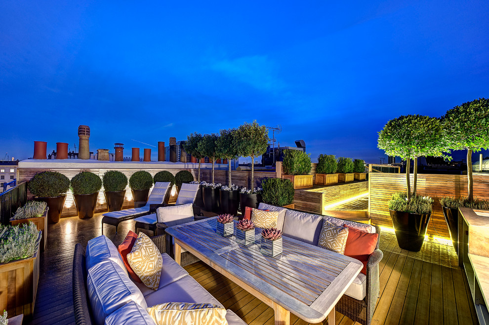 Photo of an expansive contemporary roof rooftop terrace in London with a potted garden and no cover.