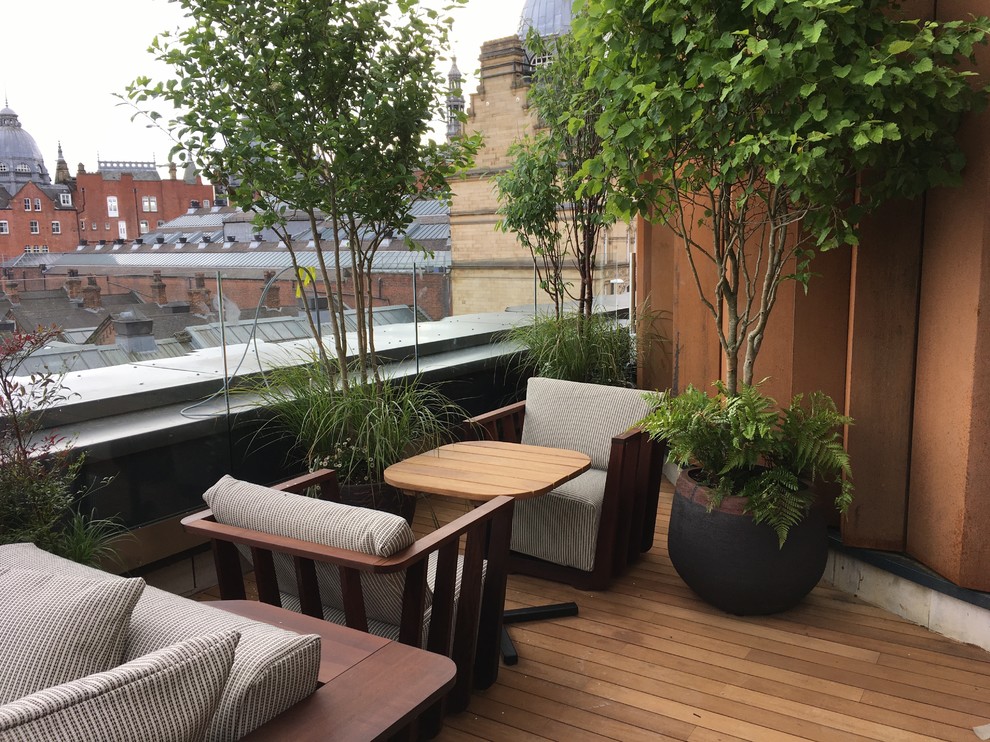 This is an example of a medium sized contemporary roof terrace in London with a potted garden.