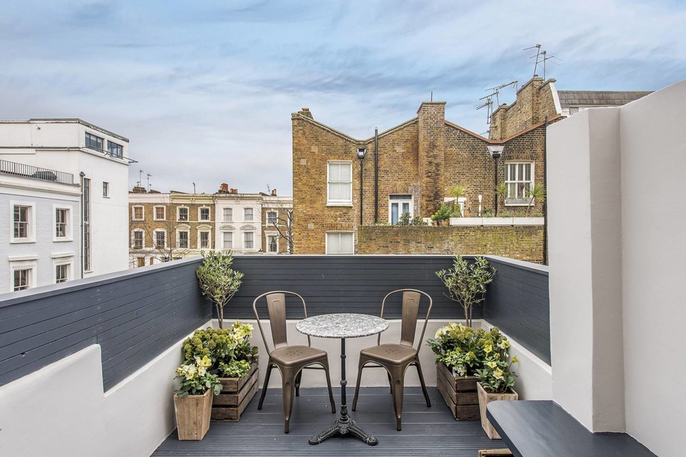 Design ideas for a small contemporary side terrace in London with a potted garden and no cover.