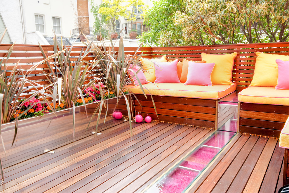 Large trendy backyard deck container garden photo in London with no cover