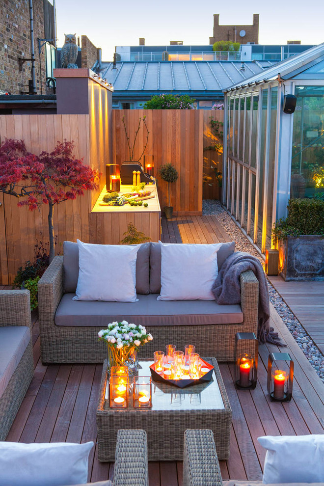 This is an example of a contemporary roof rooftop terrace in London with a bar area and a bbq area.