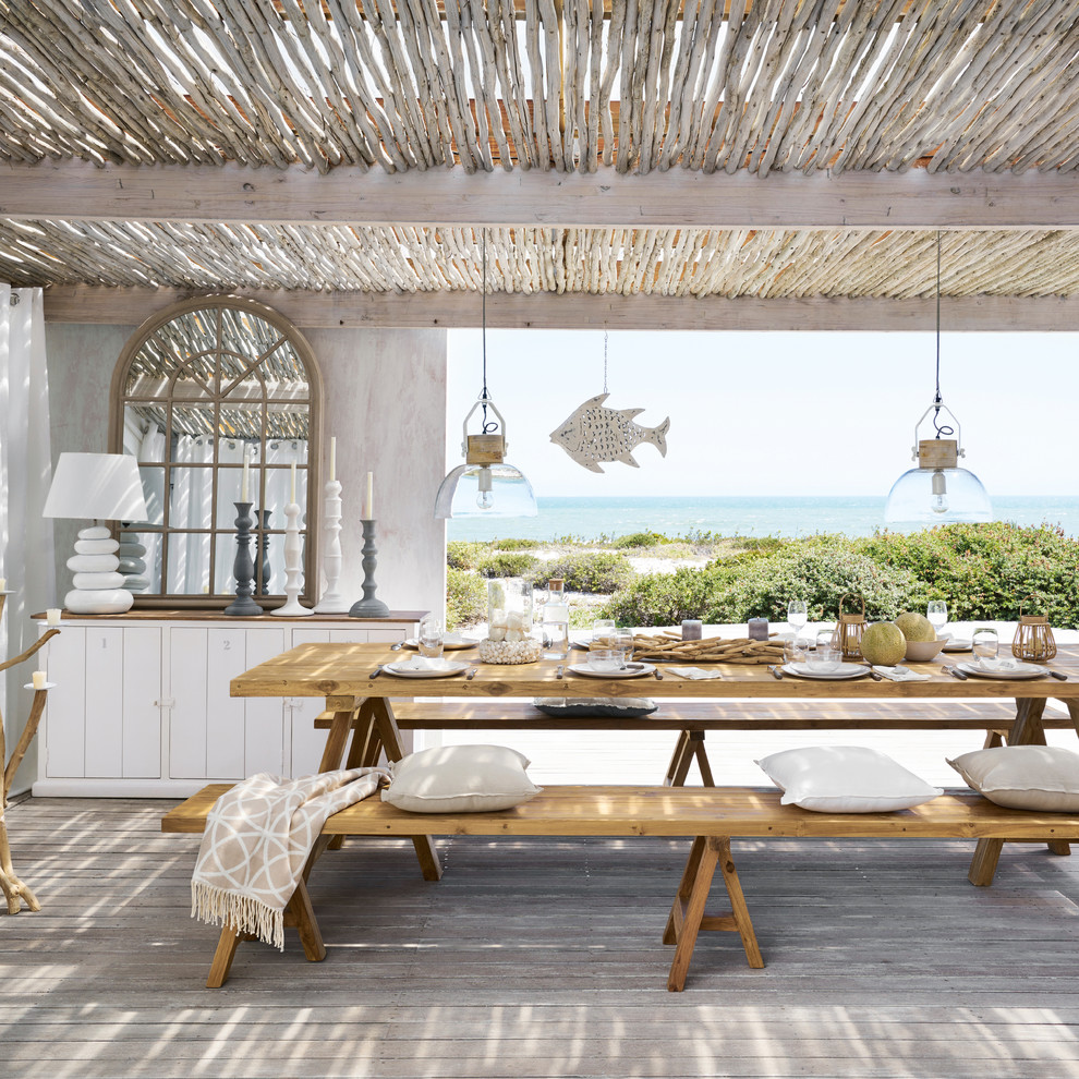 Inspiration for a coastal deck remodel in London with a pergola