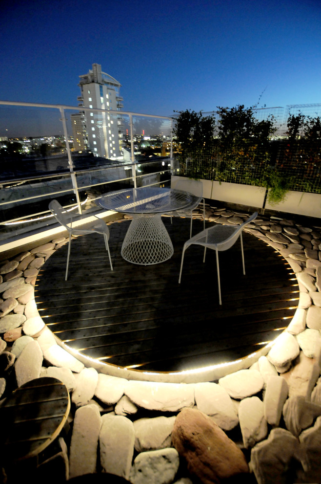 Example of a minimalist rooftop deck design in London with no cover