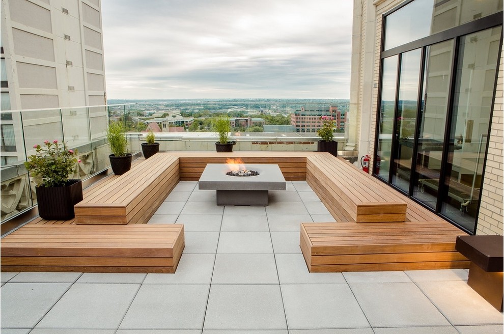 This is an example of a large contemporary roof rooftop terrace in Surrey with a fire feature and no cover.