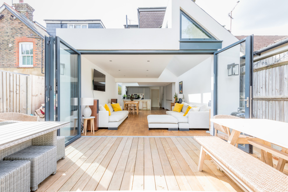 Contemporary back terrace in Sussex with no cover.