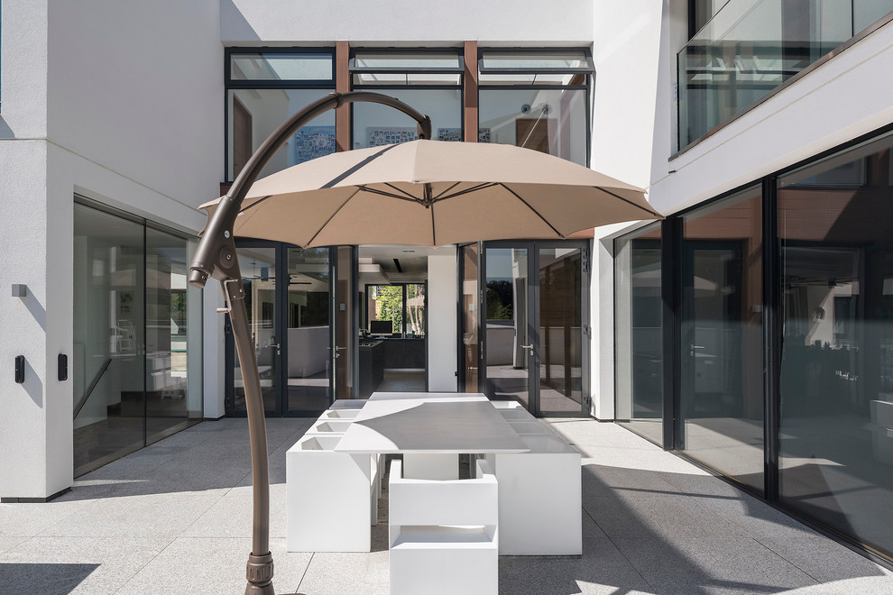 Inspiration for a large contemporary roof terrace in Hampshire with an awning.