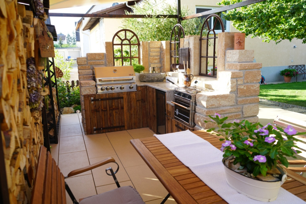 This is an example of a mediterranean terrace with an outdoor kitchen.