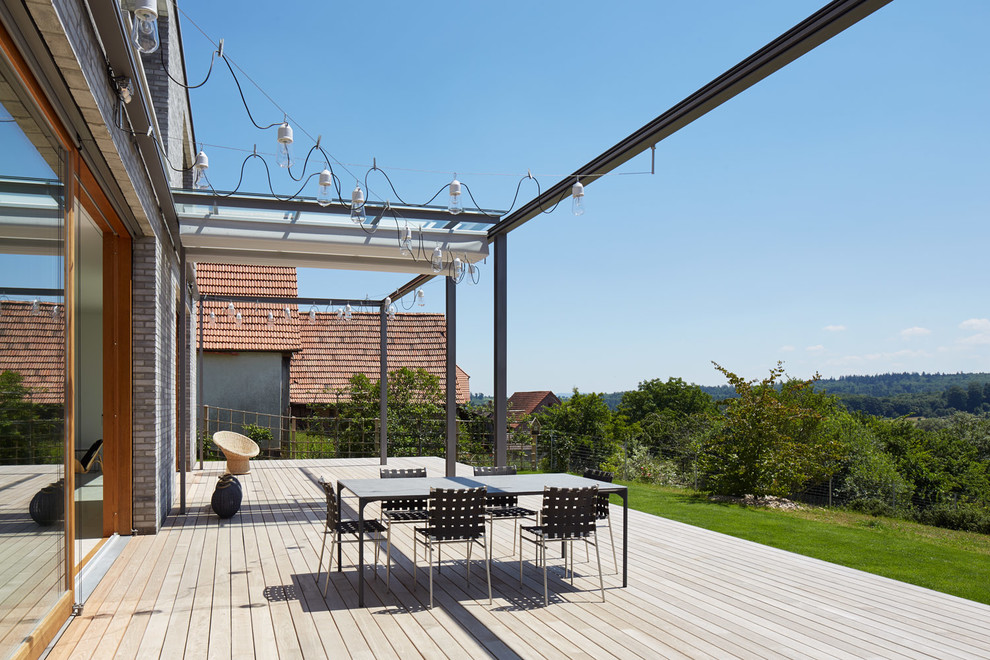 Cette photo montre une terrasse tendance de taille moyenne avec une extension de toiture.