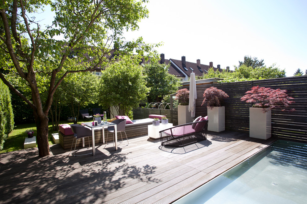This is an example of a large contemporary terrace in Munich with a potted garden and no cover.