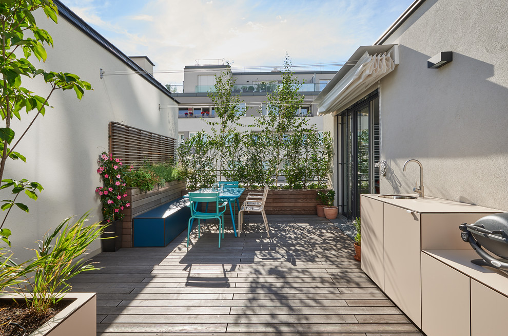 Exemple d'une terrasse tendance avec une cuisine d'été et un auvent.