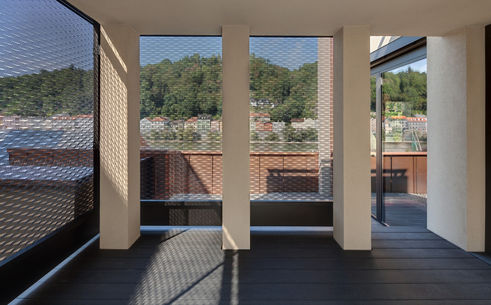 Foto de terraza contemporánea de tamaño medio en azotea y anexo de casas con privacidad y barandilla de metal