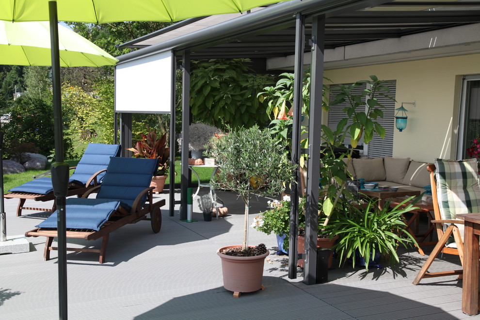 Inspiration for a large contemporary roof terrace in Other with a roof extension.