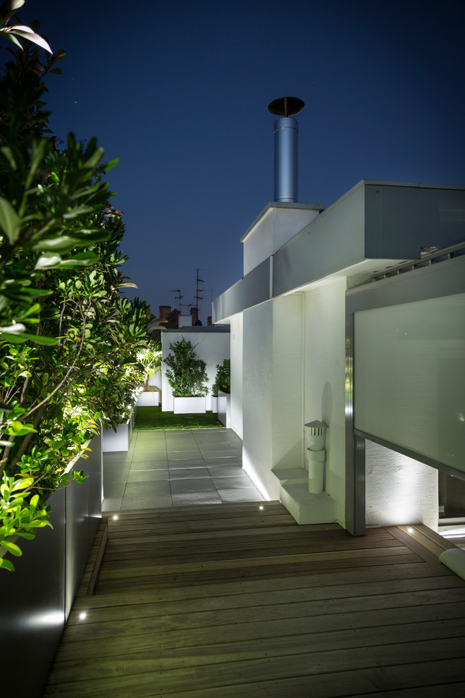 Photo of a medium sized contemporary roof terrace in Paris with a potted garden and a pergola.
