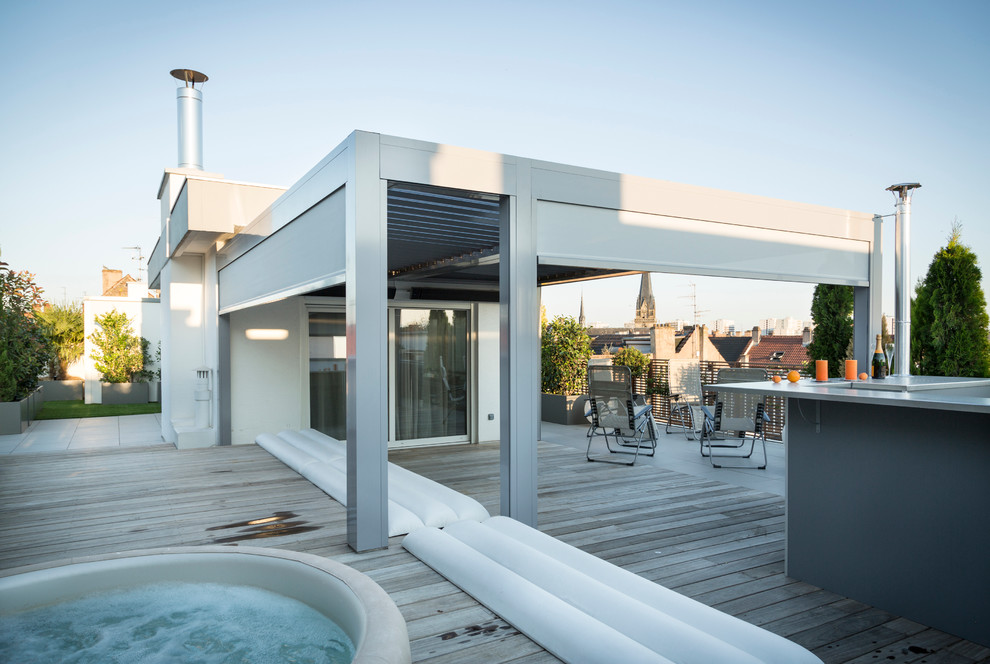 Deck container garden - mid-sized contemporary rooftop deck container garden idea in Paris with a pergola