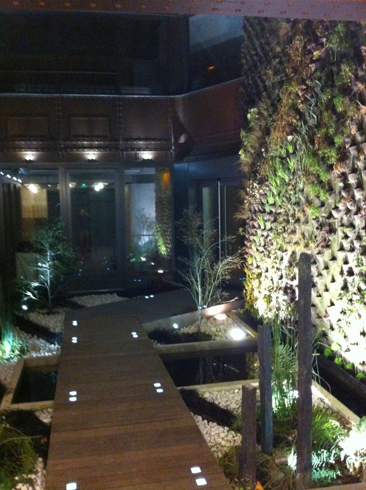 This is an example of a medium sized industrial terrace in Paris with a living wall.