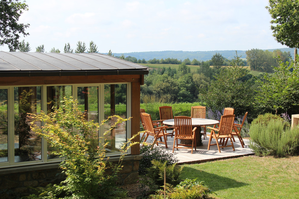 Inspiration for a country backyard patio remodel in Rennes with decking and no cover