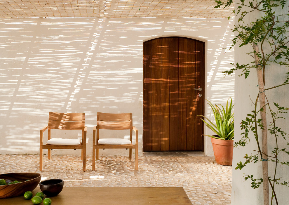 Photo of a medium sized mediterranean courtyard patio in Marseille with natural stone paving, an awning and a potted garden.