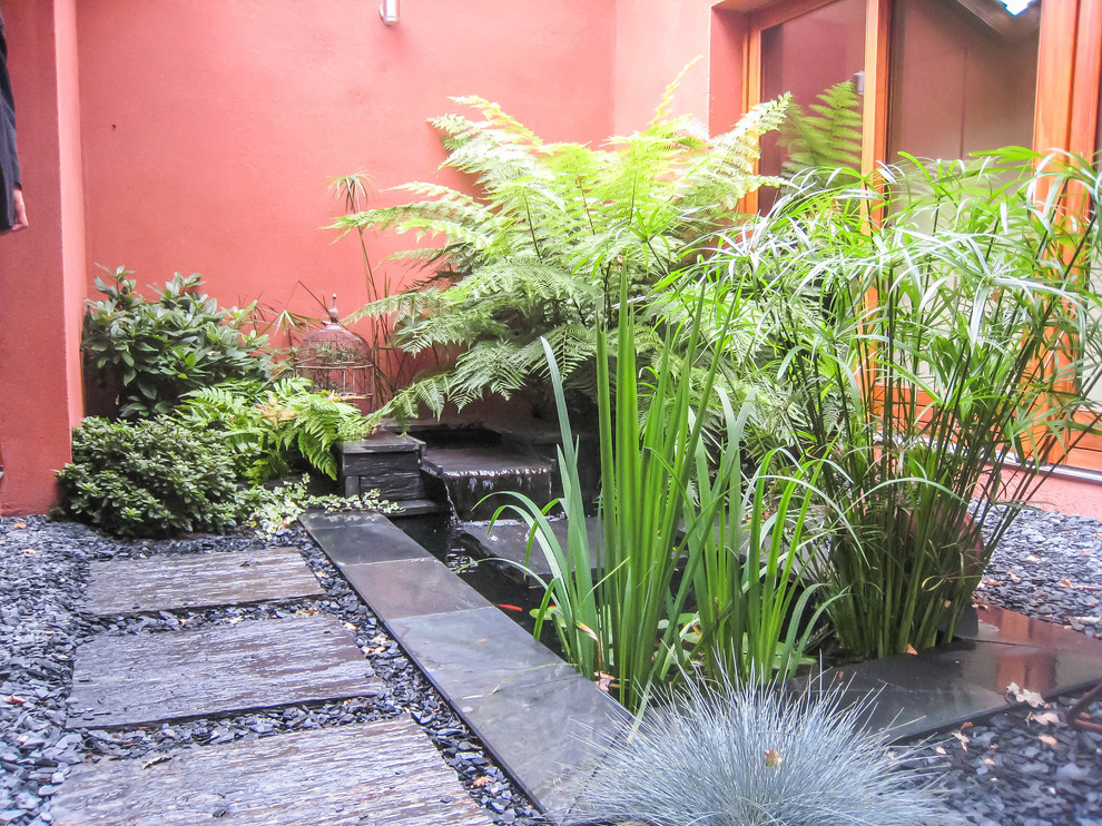Modelo de patio de estilo zen pequeño sin cubierta en patio con jardín de macetas y adoquines de piedra natural