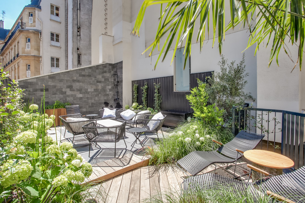 This is an example of a medium sized modern roof rooftop wood railing terrace in Paris with an outdoor shower and no cover.