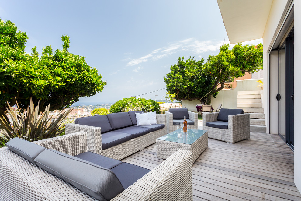 Large trendy patio photo in Nice with decking and no cover