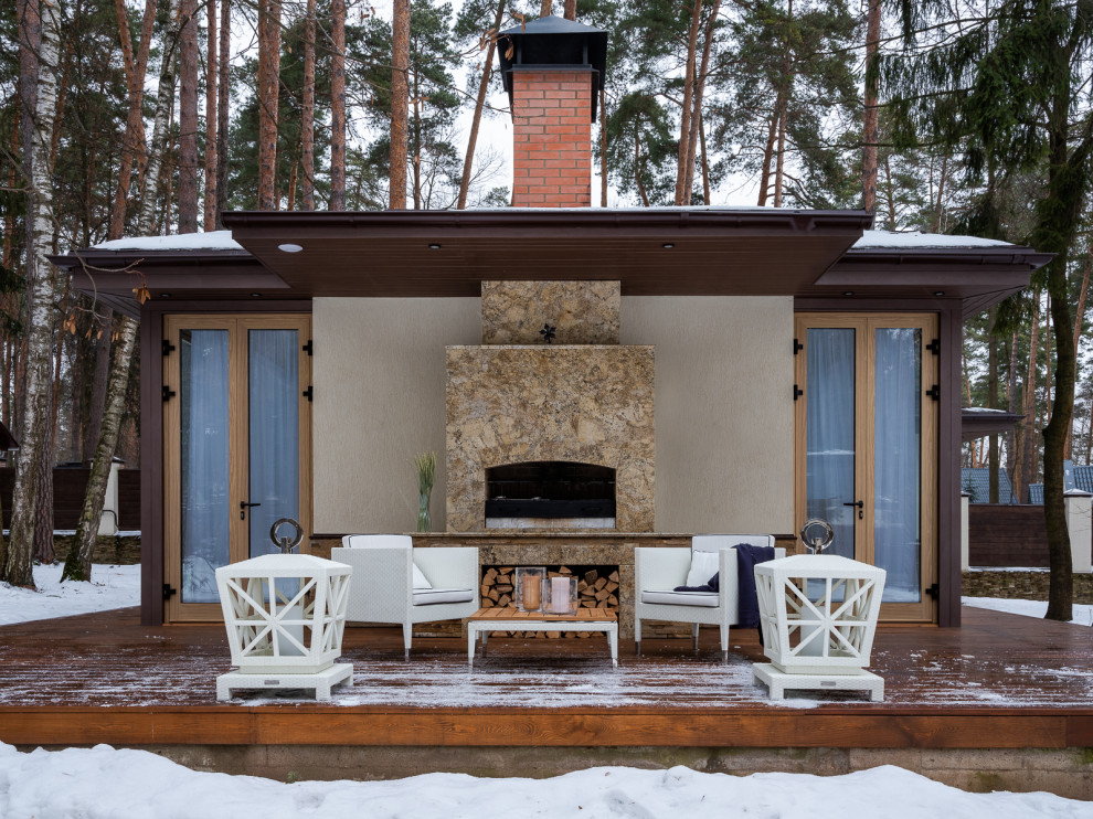 Deck - contemporary deck idea in Moscow with a fireplace