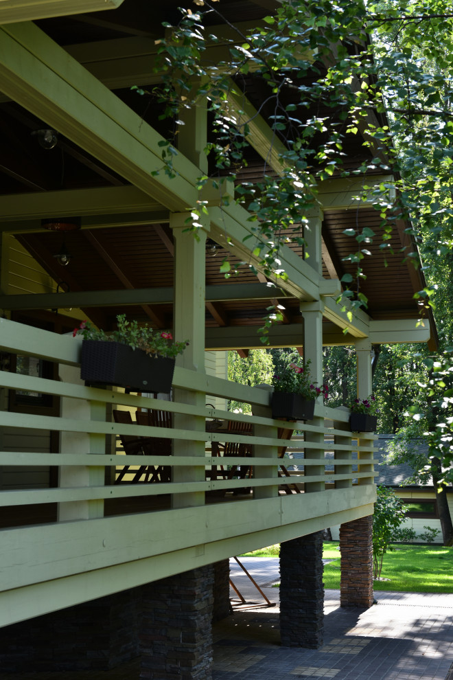 Aménagement d'une terrasse au rez-de-chaussée campagne de taille moyenne avec une cour, une extension de toiture et un garde-corps en bois.