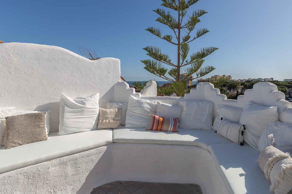 Modelo de terraza mediterránea de tamaño medio en azotea con jardín de macetas y pérgola