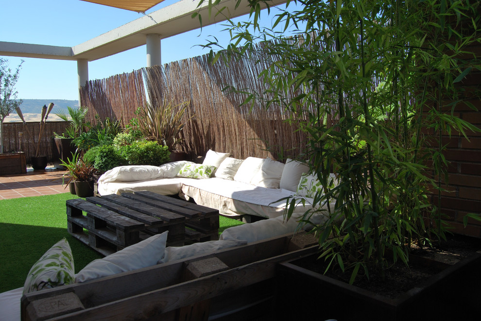 Deck container garden - small asian rooftop deck container garden idea in Madrid with an awning
