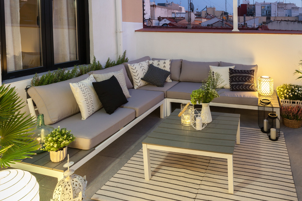 Photo of a medium sized scandinavian roof terrace in Madrid with an awning.