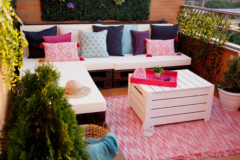 Inspiration for a small mediterranean roof terrace in Madrid with a potted garden and a roof extension.