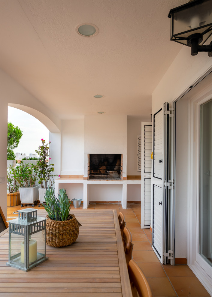 Photo of a medium sized mediterranean back veranda in Barcelona with a fireplace.