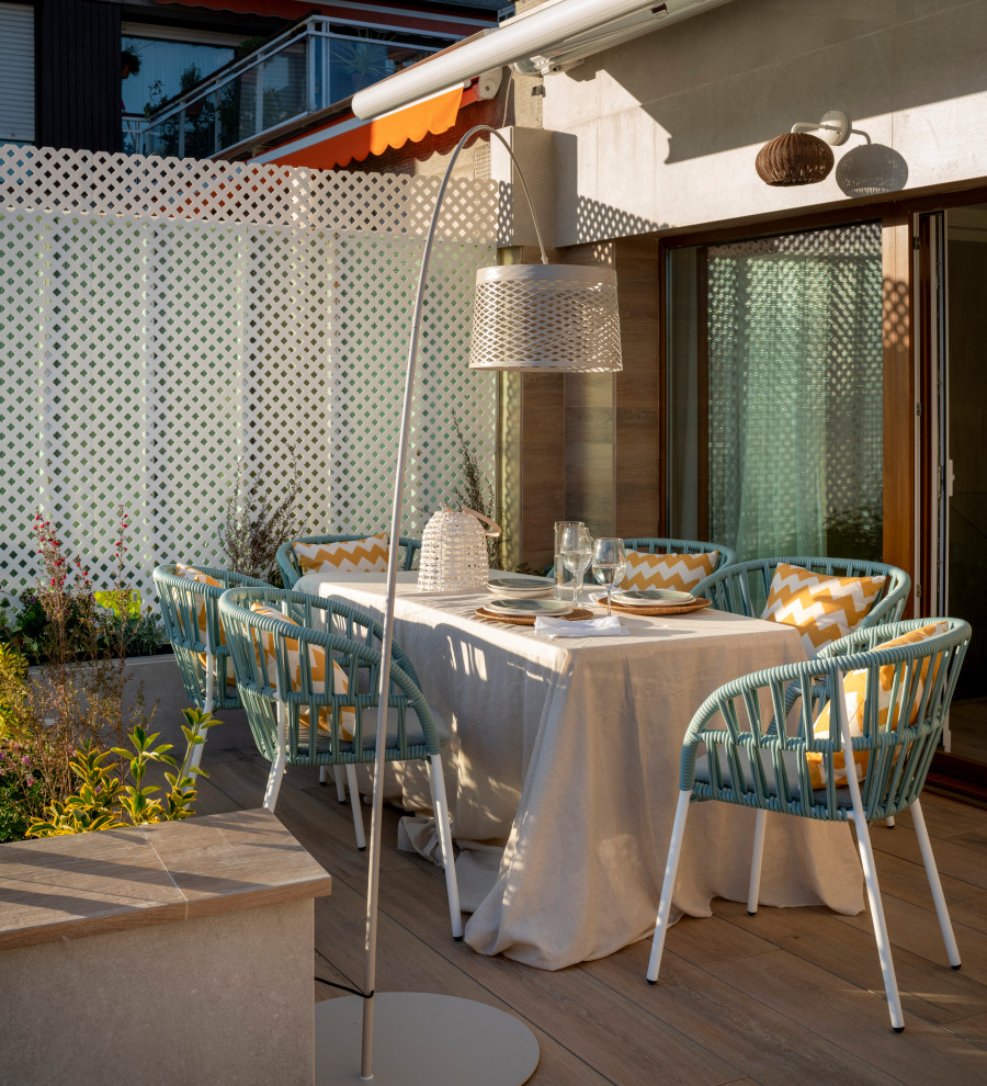 Example of a large transitional rooftop outdoor shower deck design in Bilbao with an awning