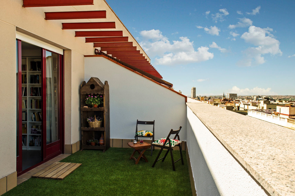 Example of a mid-sized trendy rooftop deck design in Madrid with no cover
