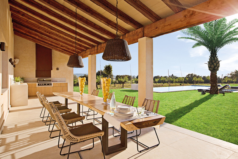 Inspiration for a large mediterranean side veranda in Palma de Mallorca with a roof extension and a bbq area.