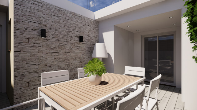 terraza con muebles de exterior, piedra en una pared, se ve el