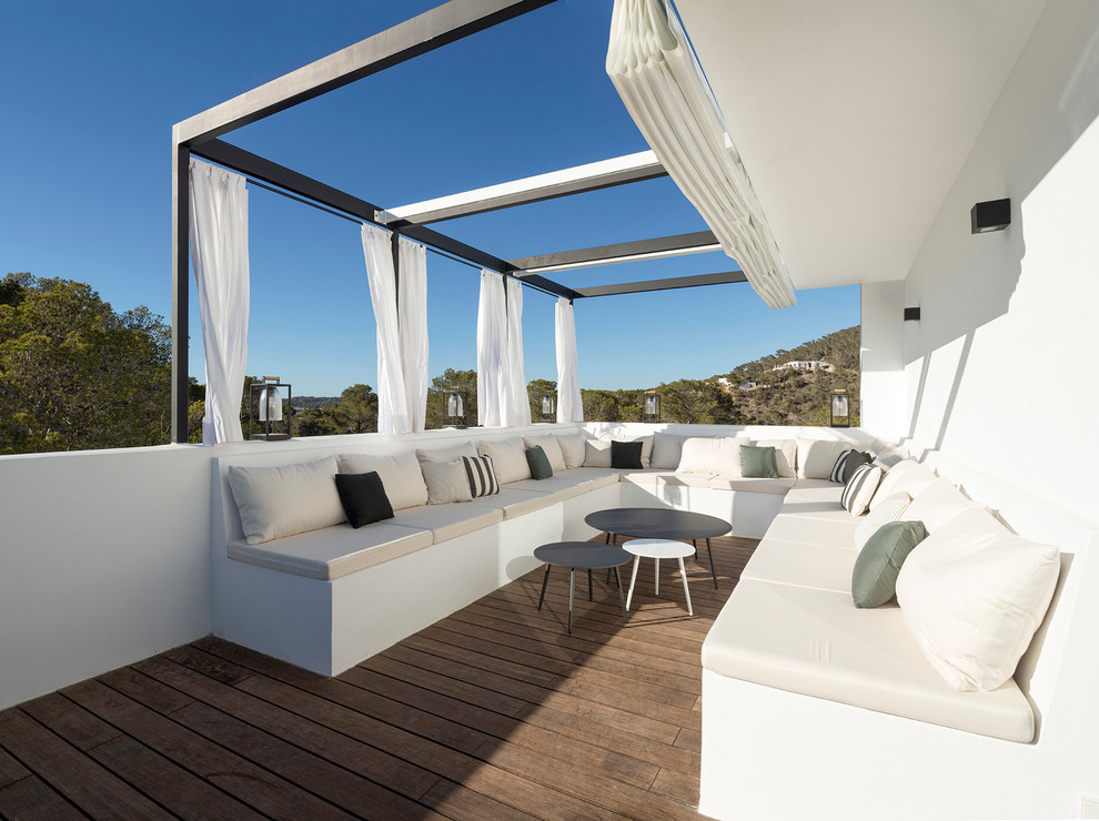 Inspiration for a large mediterranean rooftop deck remodel in Bilbao with an awning