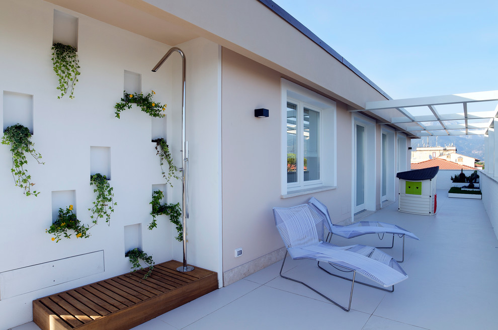 Imagen de terraza contemporánea de tamaño medio en azotea con ducha exterior y pérgola