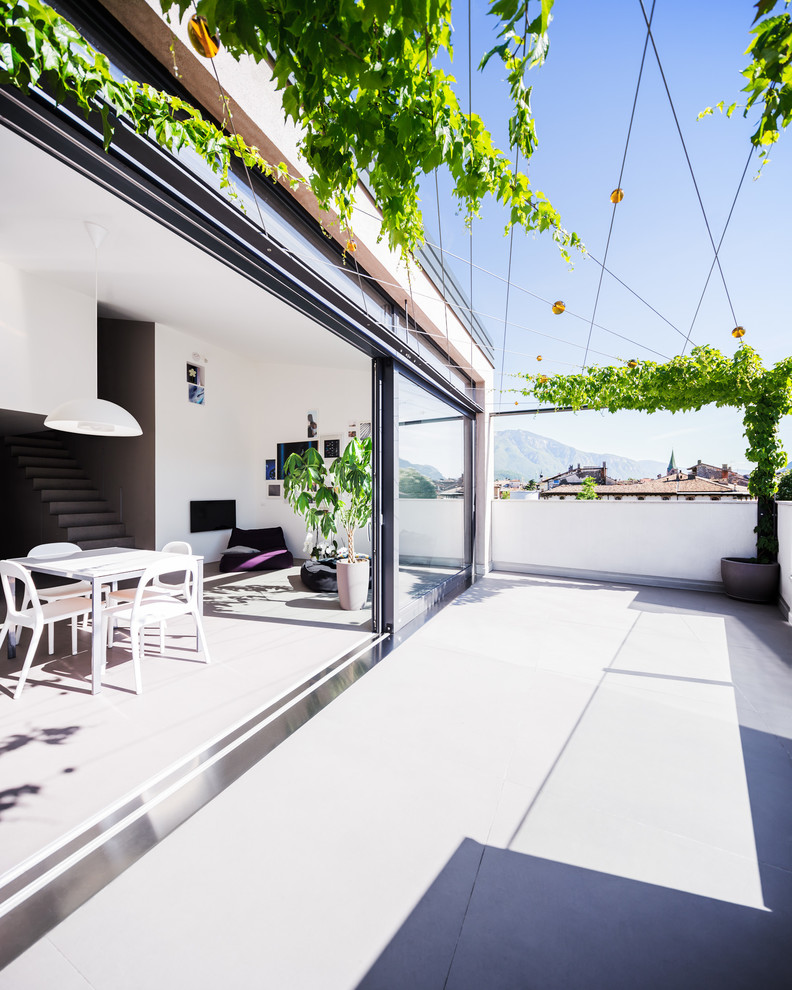 Large contemporary roof terrace in Other with a pergola.