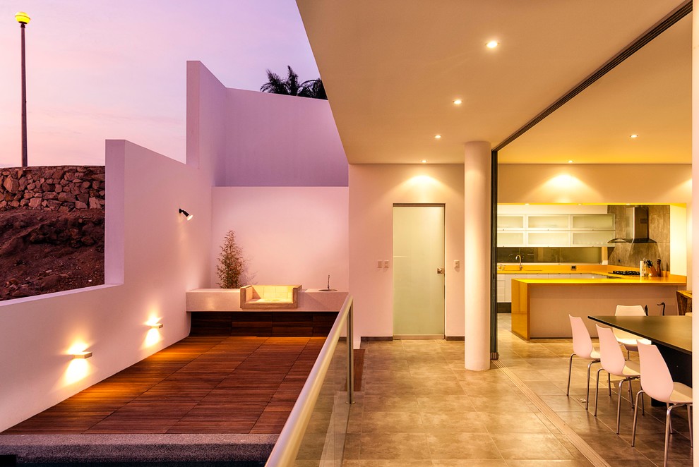 Large contemporary terrace in Catania-Palermo with an outdoor kitchen and a roof extension.