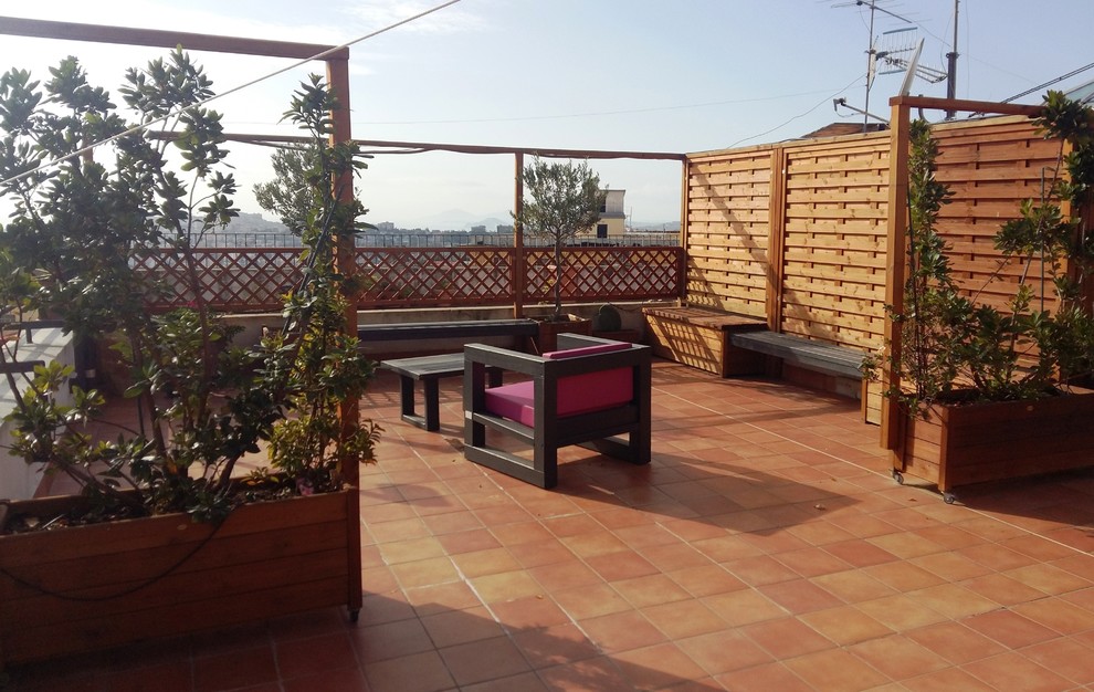 This is an example of a medium sized modern roof terrace in Naples with a pergola.