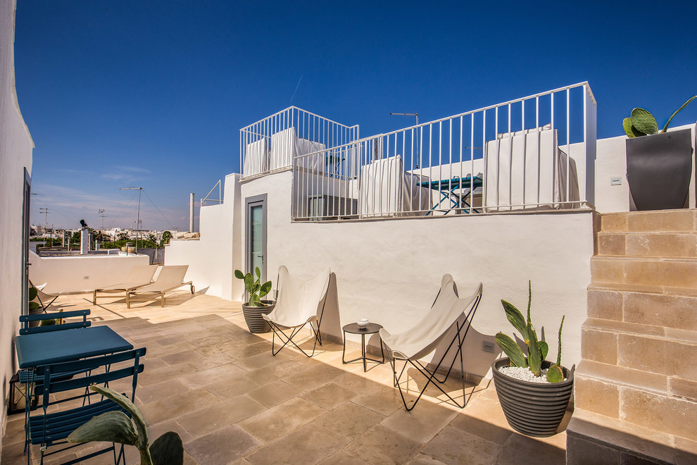 Deck - mediterranean rooftop rooftop deck idea in Rome with no cover