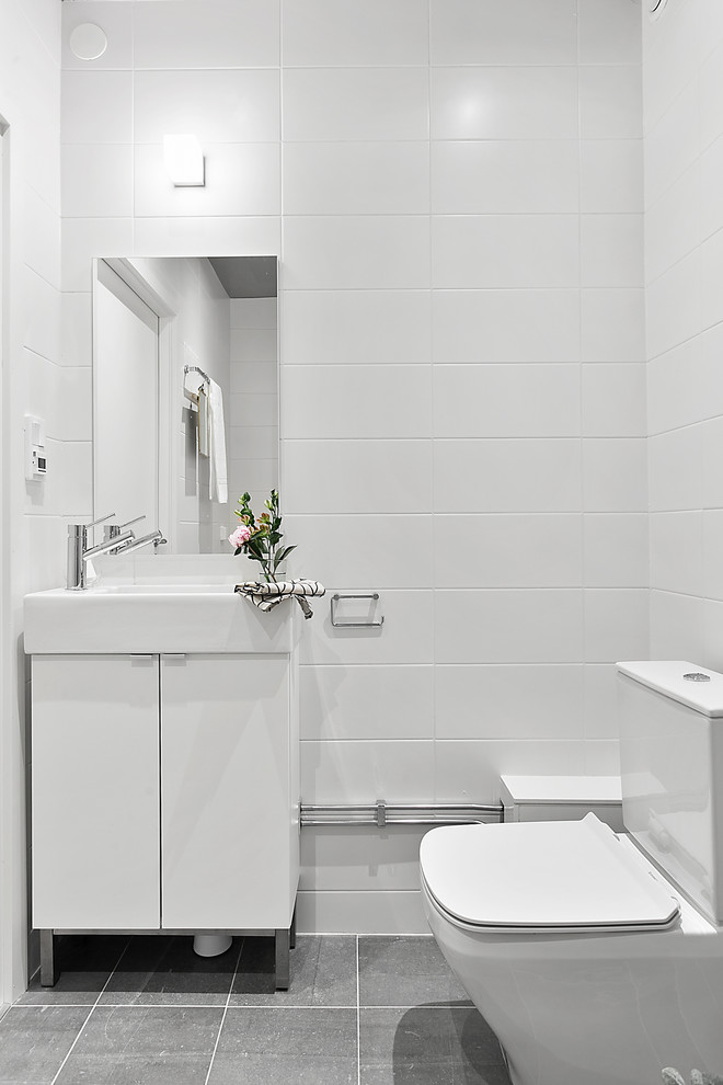 Mid-sized danish powder room photo in Stockholm with flat-panel cabinets and white cabinets