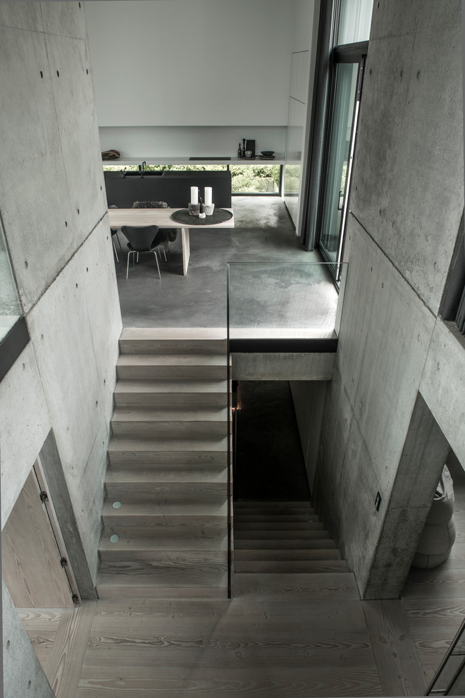 Expansive industrial wood l-shaped staircase in Other with wood risers.