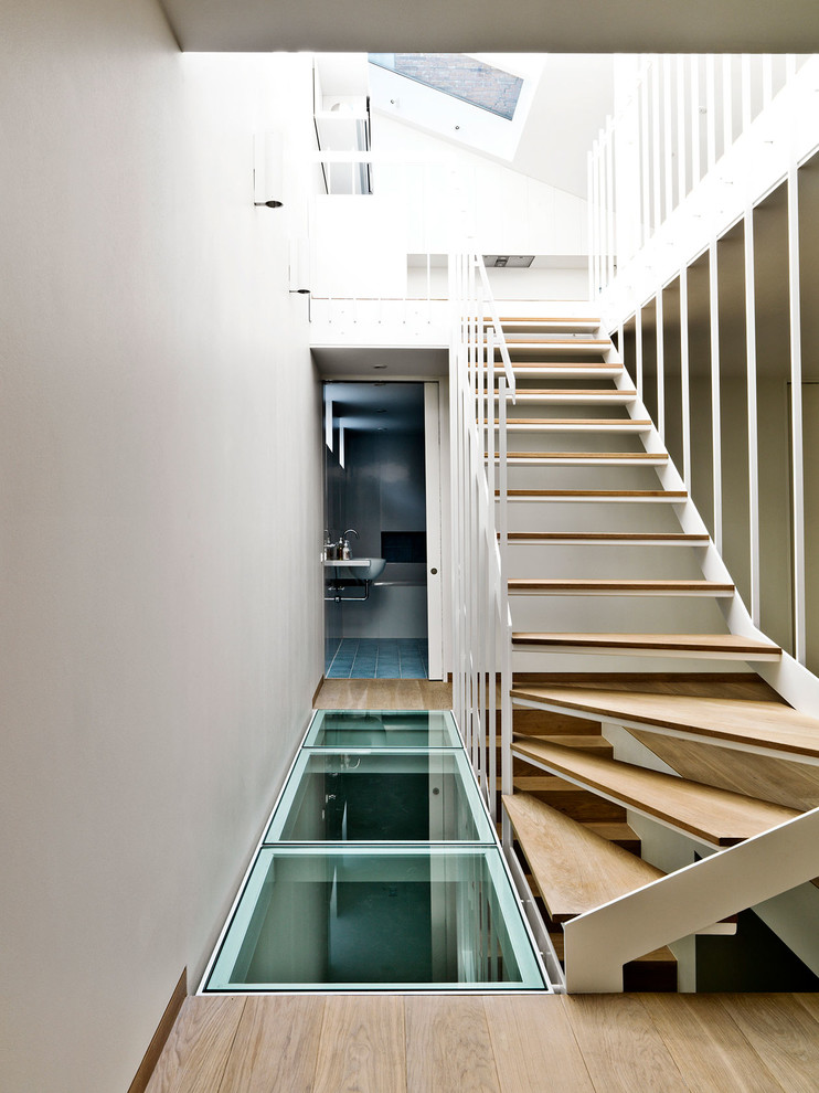 Photo of a contemporary wood l-shaped wood railing staircase in Copenhagen with wood risers.